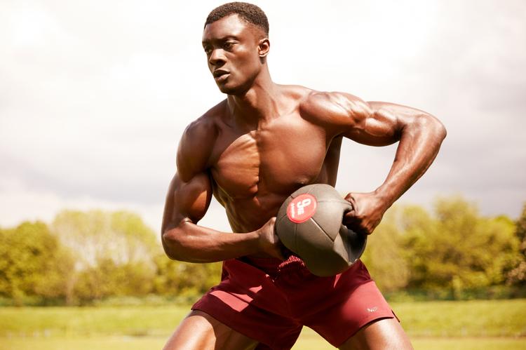 strong man lifting medicine ball