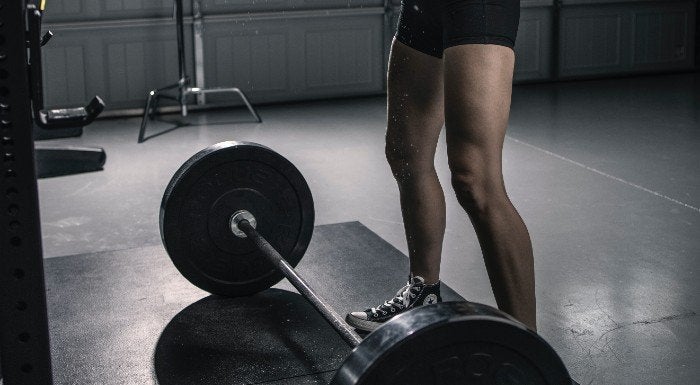 Close-up of a barbell loaded with heavy bumper plates