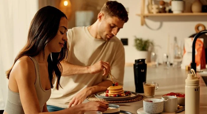 man and woman eating breakfast